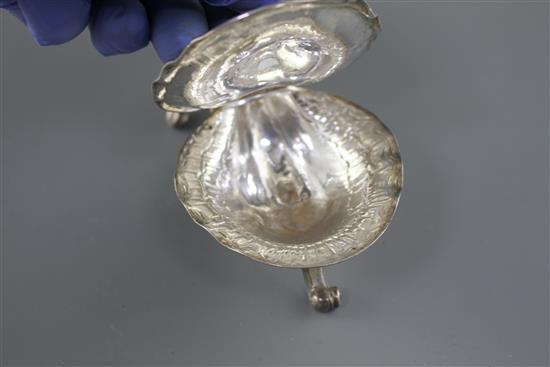 An 18th century French rococco white metal double salt, with hinged covers, on scrolling feet, marks quite rubbed, 18.3cm, 12.5oz,